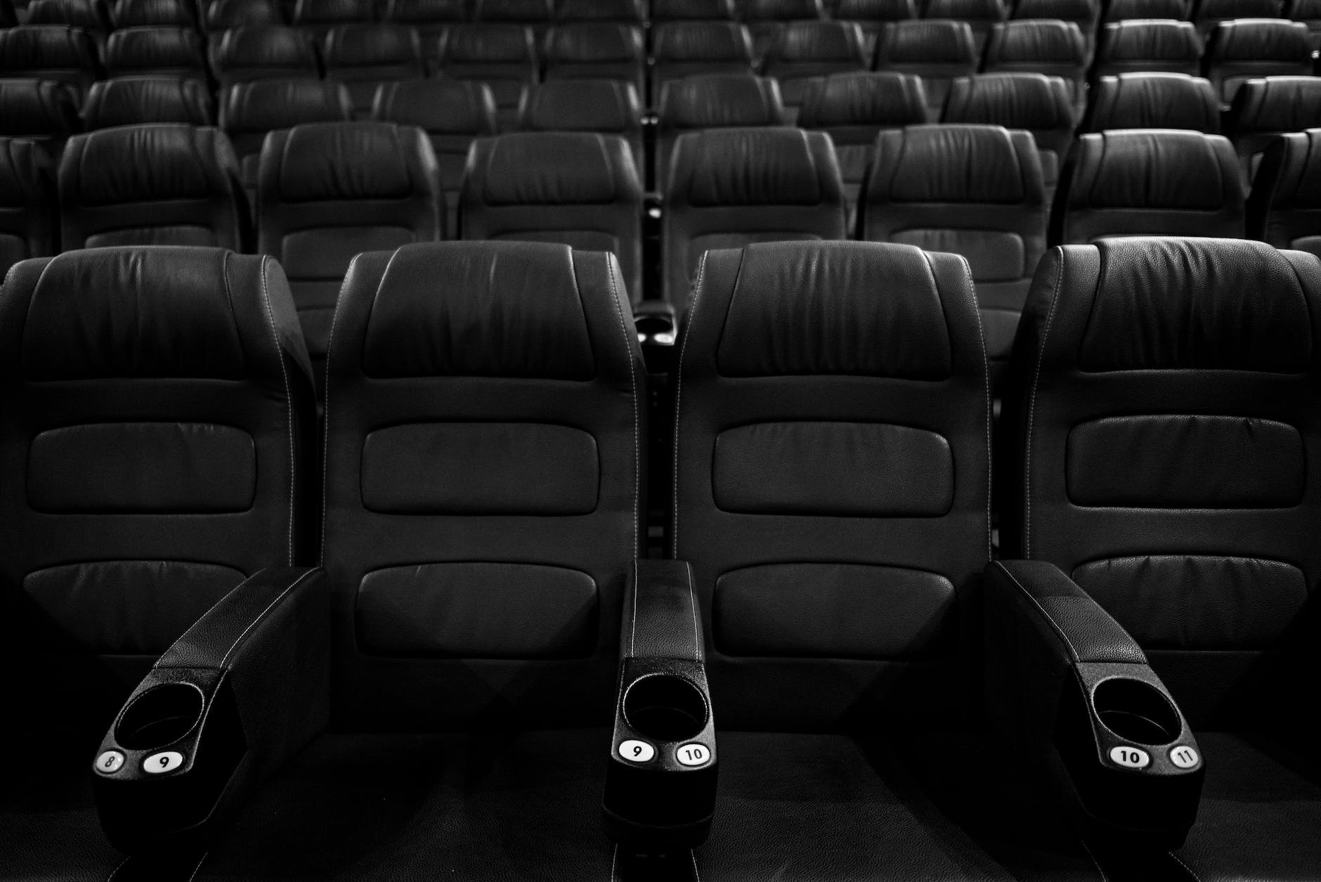 grayscale photo of empty seats